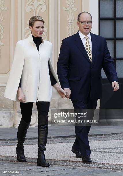 Prince Albert II of Monaco and his wife Princess Charlene arrive for the Children's Christmas ceremony at the Monaco Palace on December 16, 2015. /...