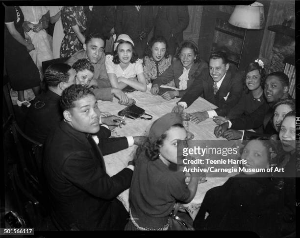 Group portrait around a table at the Loendi Club, Pittsburgh, Pennsylvania, April 1938. Pictured are, clockwise from bottom center, Thelma Spangler,...