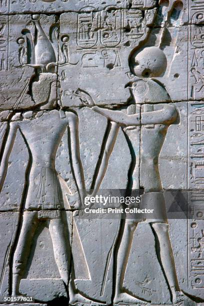 Relief of Amun-Ra giving life to Rameses II, The Ramesseum, Temple of Rameses II, Luxor, Egypt, c1250 BC. Amun-Ra holds the Ankh symbol for life.