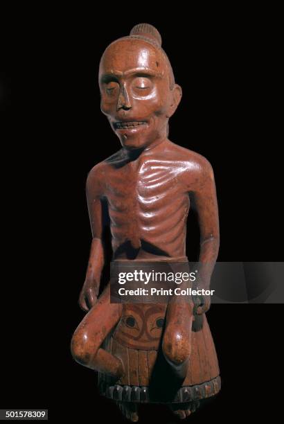 Haida tribe Native North American wooden figure of a shaman prepared for burial. The inscription says: This man was lost in the woods. He fell and...