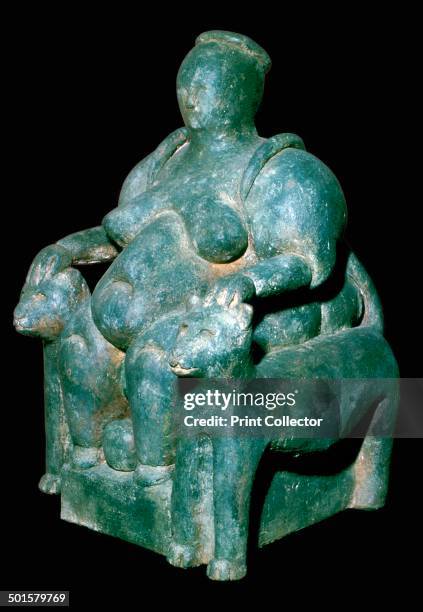 Clay sculpture of a mother-goddess from Catal Huyuk, Turkey on a leopard throne giving birth.