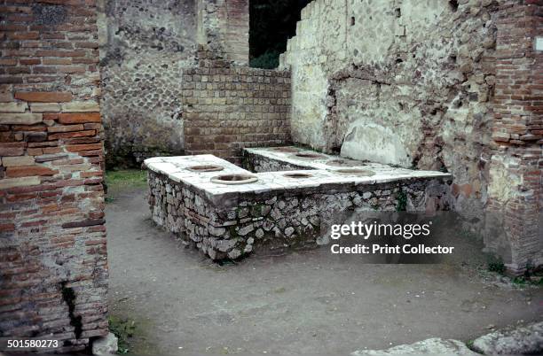 Roman food shop with its thermopolium , Herculaneum, Italy, 1st century.