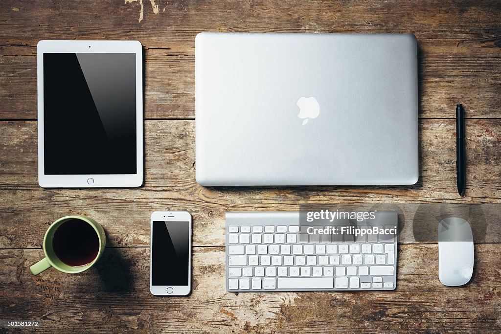 Desktop Essentials On Wooden Table