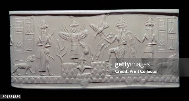 Greenstone seal of Adda, Akkadian, about 2300-2200 BC, from Mesopotamia. Akkadian religious cylinder-seal showing various gods. The sun god, holding...