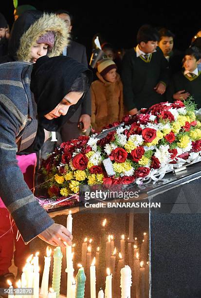 Pakistani civil society activists light candles in Quetta on December 16 on the first anniversary of attack on Army Public School Peshawar....