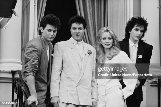 Roger Taylor, Simon Le Bon and Nick Rhodes from Duran Duran posed with American actress Tanya Roberts at a press call to promote the James Bond film...