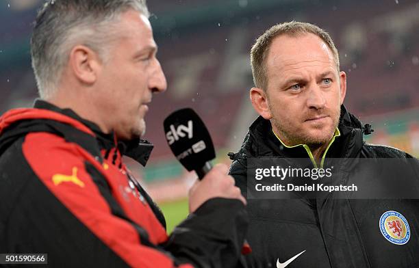 Coach Juergen Kramny of Stuttgart and Coach Torsten Lieberknecht of Braunschweig look on prior to the round of sixteen DFB Cup match between VfB...