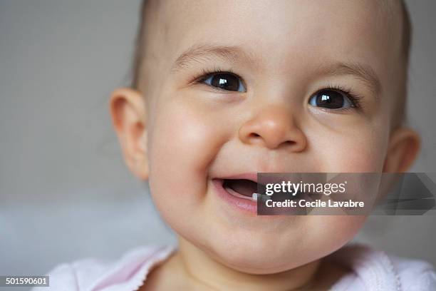 portrait of baby smiling close-up - baby tooth stock-fotos und bilder