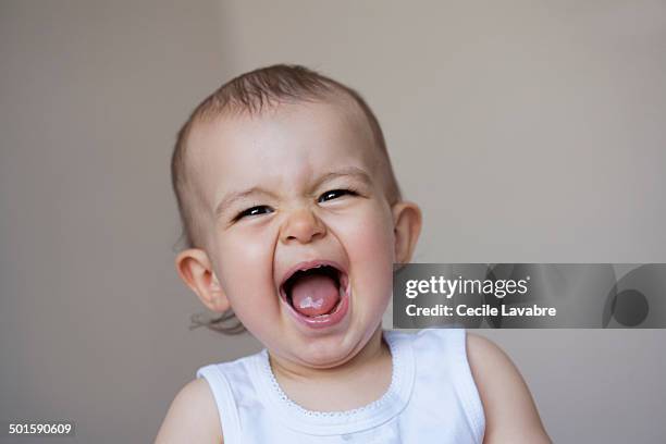 portrait of baby giggling - funny face baby stock pictures, royalty-free photos & images
