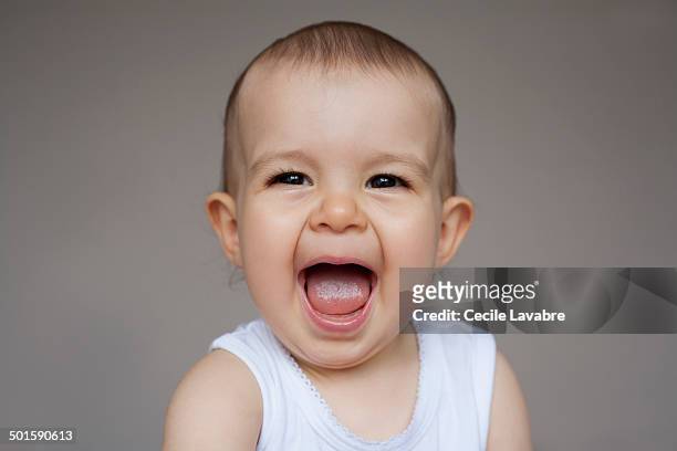 portrait of baby giggling - baby girls ストックフォトと画像