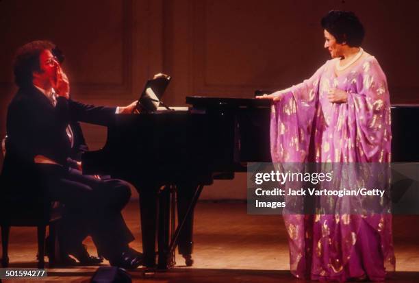 Spanish Catalan musician and lyric soprano Victoria de los Angeles smiles at Metropolitan Opera Music Director James Levine, at the piano, during a...