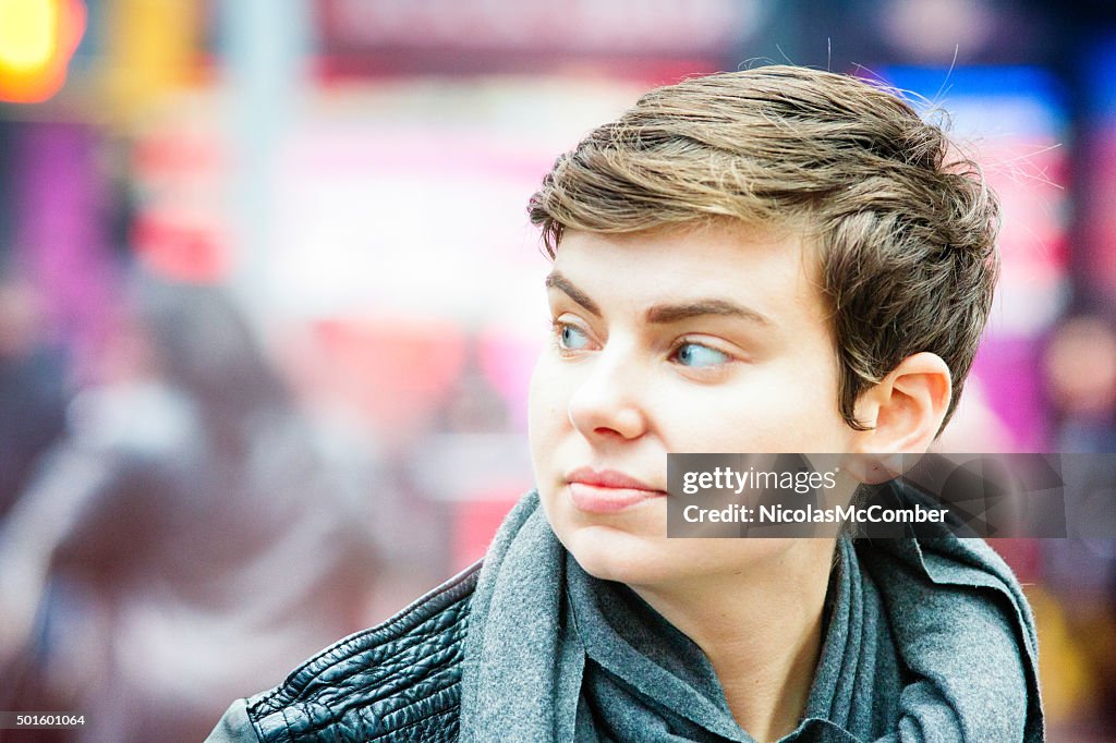 Close-up on young woman crossing the street looking left