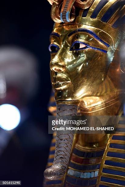 The golden funerary mask of legendary Egyptian boy king Tutankhamun is displayed at the Egyptian Museum in Cairo after its restoration, on December...