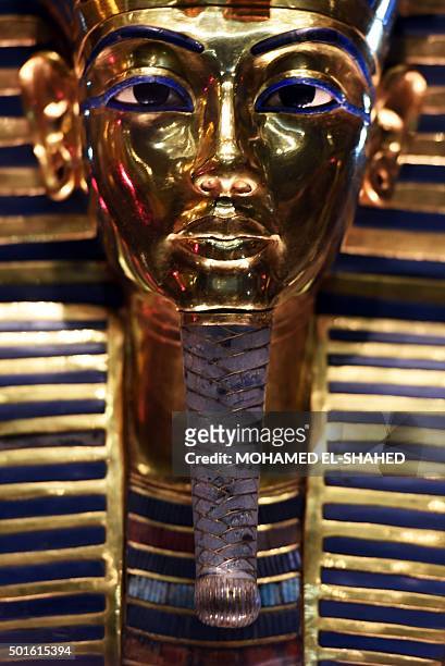 The golden funerary mask of legendary Egyptian boy king Tutankhamun is displayed at the Egyptian Museum in Cairo after its restoration, on December...