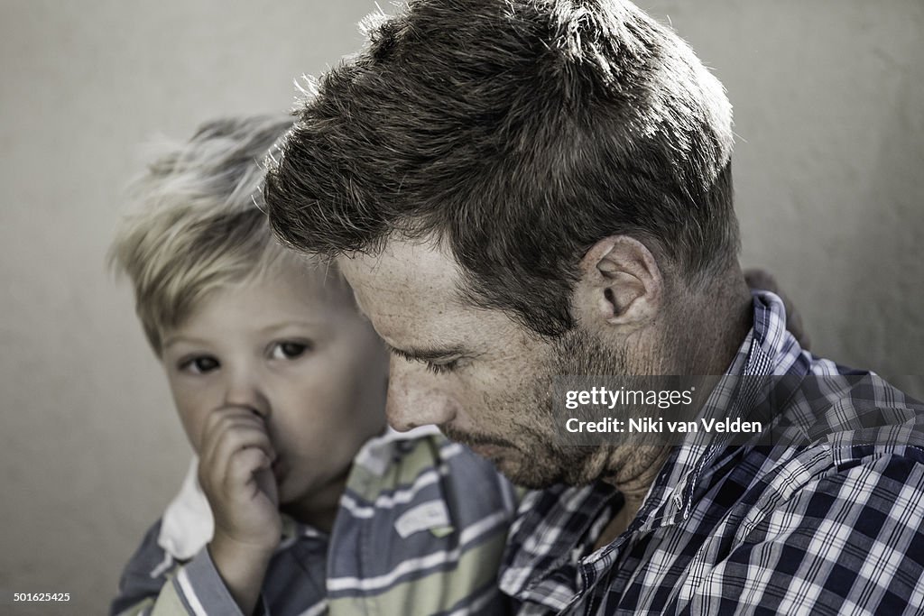 Father holding young son