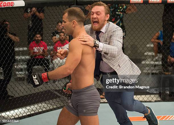 Conor McGregor jumps into the cage to congratulate Artem Lobov after his knockout victory over Julian Erosa during the filming of The Ultimate...