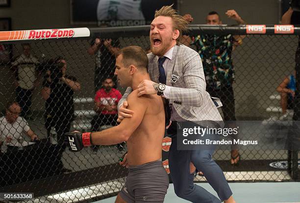 Conor McGregor jumps into the cage to congratulate Artem Lobov after his knockout victory over Julian Erosa during the filming of The Ultimate...