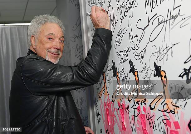 Singer Tom Jones signs the wall at AOL Studios when he visits for AOL Build Presents Tom Jones, "Long Lost Suitcase" at AOL Studios In New York on...