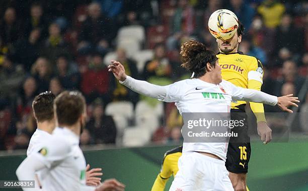 December 16: Jeong-Ho Hong of Augsburg and Mats Hummels of Dortmund vie for the ball during the round of sixteen German Cup match between FC Augsburg...