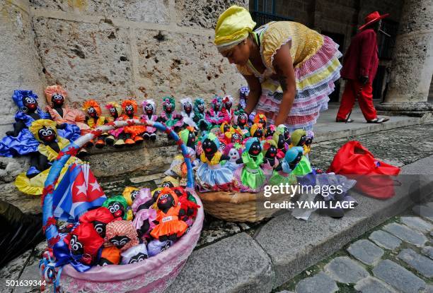 Cuban vendor displays dolls for sale at a street of the Old Havana, on December 16, 2015. Crowds of foreign tourists walk at the historical center of...