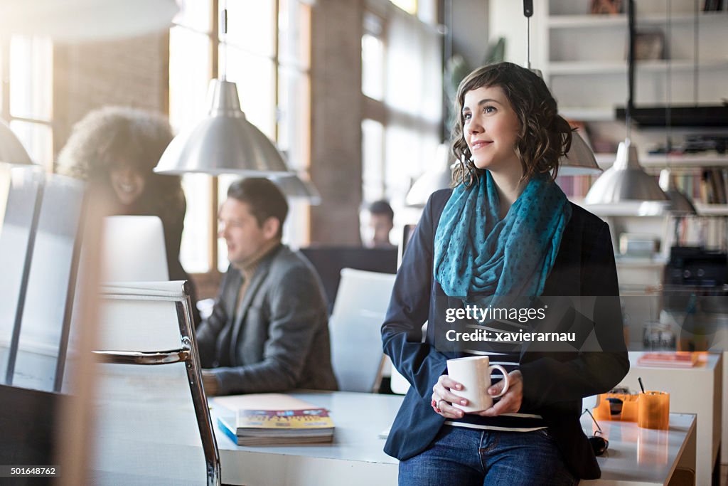Portrait of smiling office worker relax having a coffee