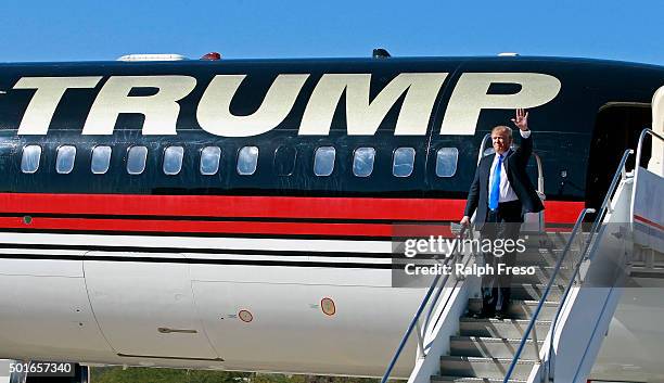 Republican presidential candidate Donald Trump waves to the crowd as he arrives at a campaign event at the International Air Response facility on...