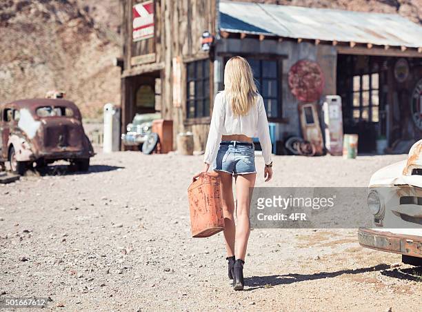 ghost town, woman at a gas station - american glamour models stock pictures, royalty-free photos & images