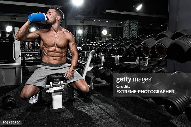 man in the gym drinking protein shake drink - bodybuilding stock pictures, royalty-free photos & images