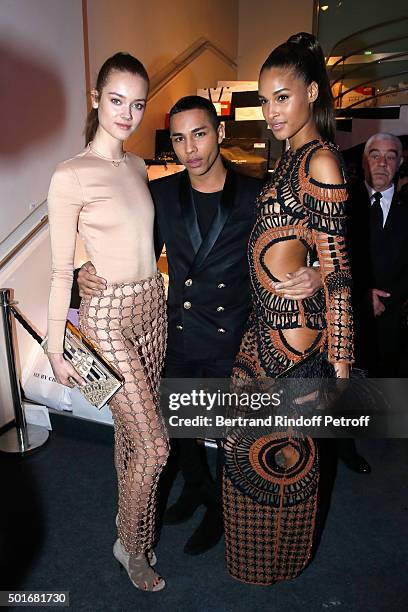 Balmain Fashion Designer Olivier Rousteing standing between Cindy Bruna and Model attend the Annual Charity Dinner hosted by the AEM Association...