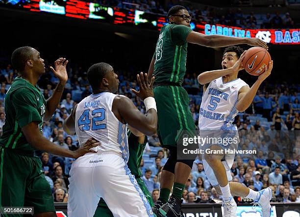 Marcus Paige of the North Carolina Tar Heels drives against Paul Blake of the Tulane Green Wave during their game at the Dean Smith Center on...
