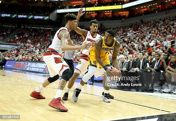 Damion Lee and Trey Lewis of the Louisville Cardinals defend Kendrick Ray of the Kennesaw State Owls at KFC YUM! Center on December 16, 2015 in...