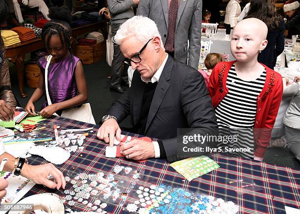 John Slattery plays with St. Jude's patient child Kenlie at Brooks Brothers holiday celebration with St. Jude Children's Research Hospital Brooks...