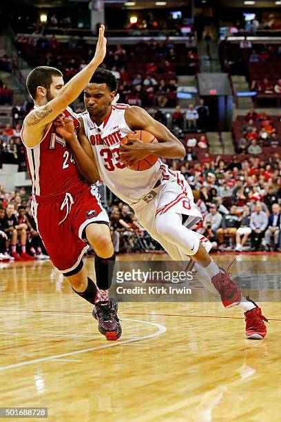 Keita Bates-Diop of the Ohio State Buckeyes drives towards the hoop while being defended by Michael Orris of the Northern Illinois Huskies during the...
