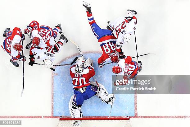 Goalie Braden Holtby of the Washington Capitals makes a save in the second period on Mark Borowiecki of the Ottawa Senators at Verizon Center on...