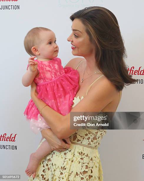 Miranda Kerr poses alongside a baby at Westfield Bondi Junction on December 17, 2015 in Sydney, Australia.