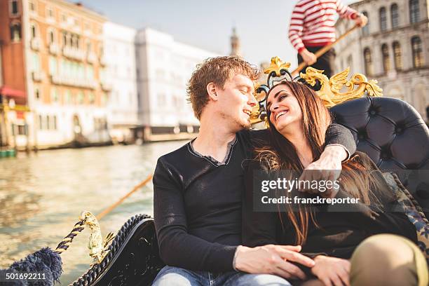 romantic couple togetherness on the gondola in venice - venice with couple stockfoto's en -beelden