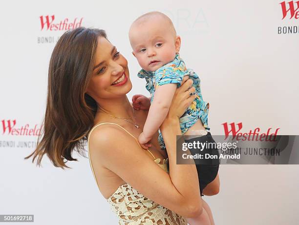 Miranda Kerr poses alongside a baby at Westfield Bondi Junction on December 17, 2015 in Sydney, Australia.