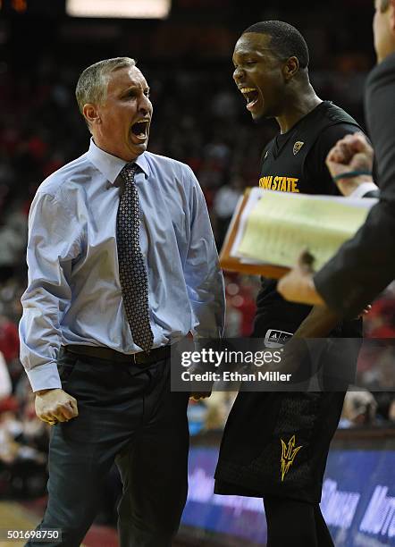 Head coach Bobby Hurley of the Arizona State Sun Devils celebrates with Willie Atwood on the bench late in the team's 66-56 win over the UNLV Rebels...