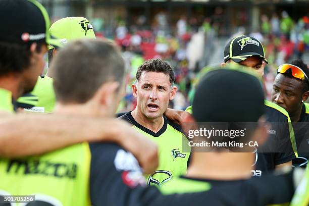 Thunder captain Michael Hussey speaks to his players before the Big Bash League match between the Sydney Thunder and the Sydney Sixers at Spotless...