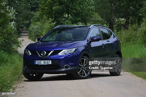 nissan qashqai on the road - nissan qashqai stock pictures, royalty-free photos & images