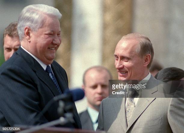 Former president Boris Yeltsin and Russian President Vladimir Putin, right, smile as they speak outside the newly opened Our Lady of Kazan Cathedral...