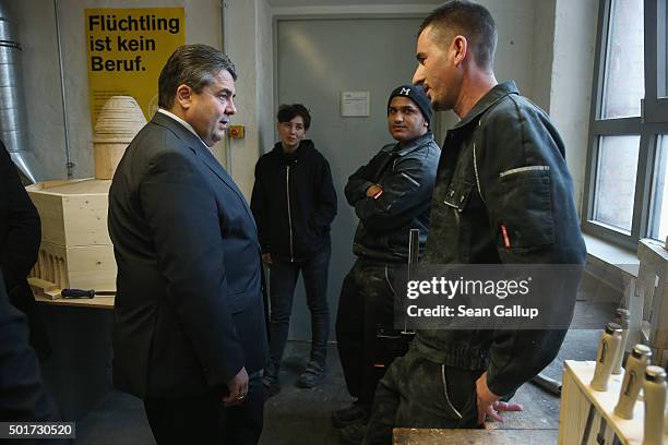 German Vice Chancellor and Economy and Energy Minister Sigmar Gabriel chats with two immigrants from Kosovo participating in the cabinet-making...