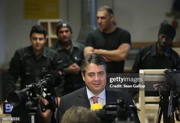 German Vice Chancellor and Economy and Energy Minister Sigmar Gabriel speaks to the media as asylum-applicants from Syria, Kosovo, Lebanon and Gambia...