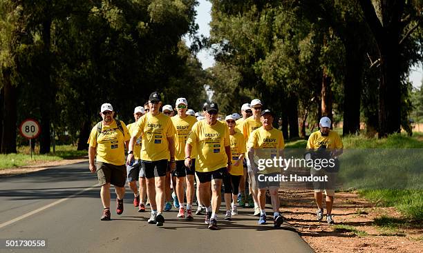 In this handout image provided by Philip Brown, Sir Ian Botham and his supporters walk during the 'Beefy Walking the Rainbow Nation' charity walk...