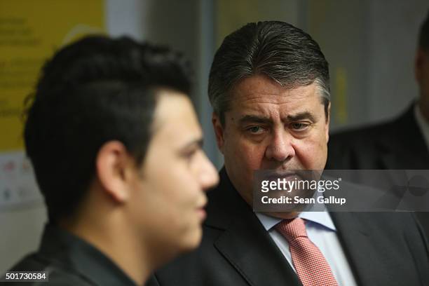 German Vice Chancellor and Economy and Energy Minister Sigmar Gabriel chats with a refugee from Syria participating in the cabinet-making tradecrafts...