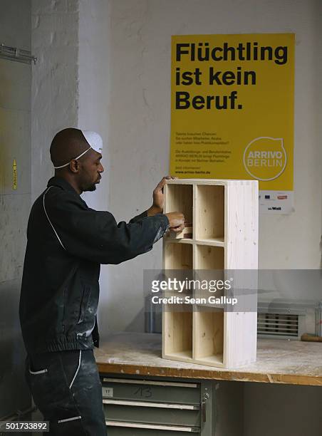 An asylum-applicant from Africa participates in the cabinet-making tradecrafts exposure program at the Arrivo center on December 17, 2015 in Berlin,...