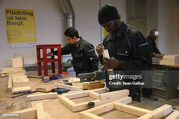 Asylum-applicants from Syria and Africa participate in the cabinet-making tradecrafts exposure program at the Arrivo center on December 17, 2015 in...