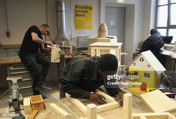 Asylum-applicants from Lebanon, Gambia and Kosovo participate in the cabinet-making tradecrafts exposure program at the Arrivo center on December 17,...