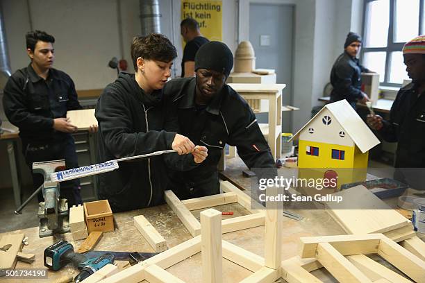 Instructor Mona Nasser helps asylum-applicant Ala Hage from Gambia as asylum-seekrs from countries including Lebanon, syria and Kosovo work on...