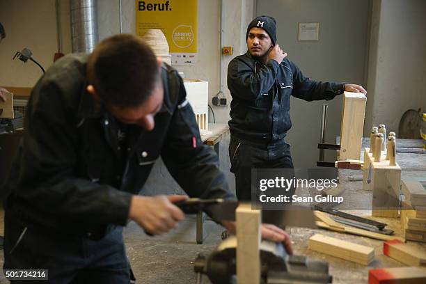 Asylum-applicants from Kosovo participate in the cabinet-making tradecrafts exposure program at the Arrivo center on December 17, 2015 in Berlin,...